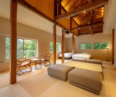 Tatami flooring with low beds, wooden beams and windows overlooking greenery at Namegawaonsen Fukushimaya Yamagata Tōhoku Japan