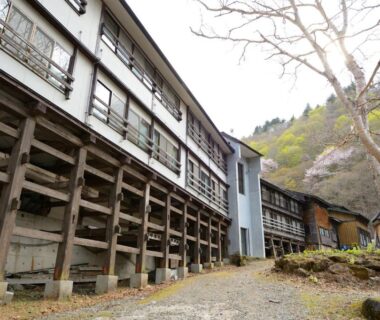 Exterior of multi-story ryokan on wooden stilts at Namegawaonsen Fukushimaya in Yamagata