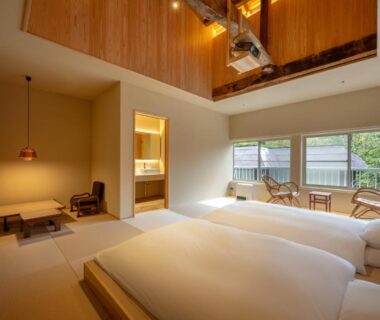 Low twin beds on tatami with indoor wooden tub visible at Namegawaonsen Fukushimaya Yamagata