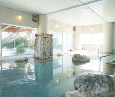 Indoor onsen bath with rock features at Nangoku Hotel in Chiba, Kanto