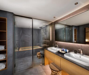 Double-sink bathroom with glass shower and wooden shelving at Nanzenji sando KIKUSUI Kyoto