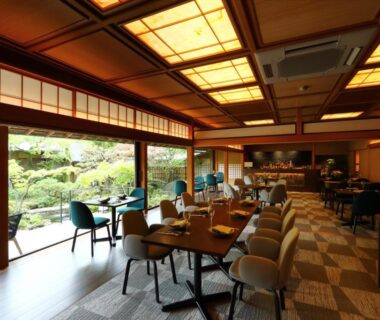 Dining area with shoji screens, wooden ceiling and garden view at Nanzenji sando KIKUSUI, Kyoto