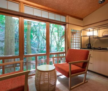 Tatami room with low table, armchairs and forest view at Nara Kasugaokuyama Tsukihitei, Nara
