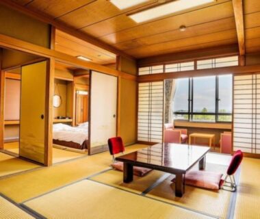 Traditional tatami room with low table, zabuton seating, shoji screens and futon in adjacent alcove at Nara Park Hotel