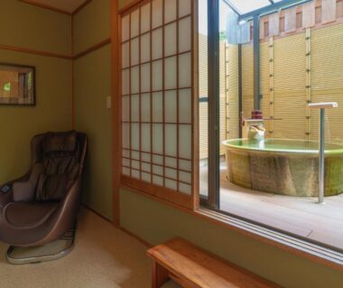 Tatami room with shoji screens, massage chair and wooden deck tub at Narashino no sato Gyokusui Shizuoka