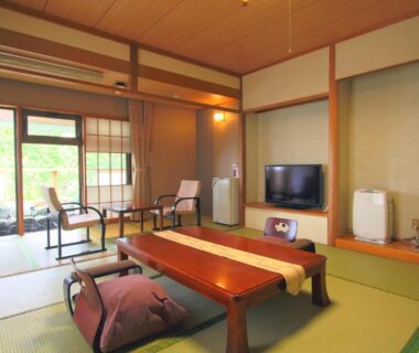 Traditional tatami room with low table, cushions, TV and sliding shoji doors at Nasu Hoshi no Akari, Tochigi