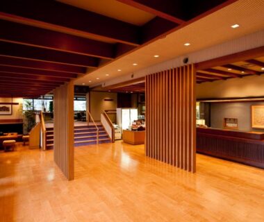 Spacious wooden reception area with seating and staircase at Nasu Onsen Sanraku in Tochigi, Kanto, Japan