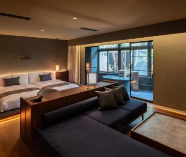 Twin beds and low lounge sofa in modern room at Nasu-Onsen Shinshun no Kago Hewitt Resort, Tochigi