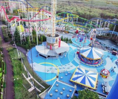 Aerial view of colorful amusement park rides and walkways, shown for Nasushiobara Ichimantei, Tochigi, Kantō, Japan