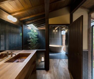 Interior with wooden vanity, freestanding tub, shoji screens and small courtyard at Nazuna Kyoto Gosho, Kyoto