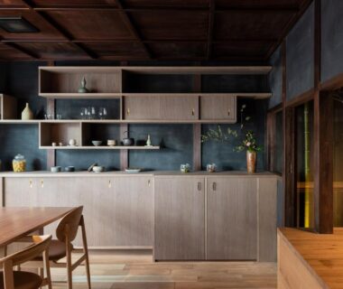 Serene wooden dining area with table and shelving at Nazuna Kyoto Gosho ryokan in Kyoto