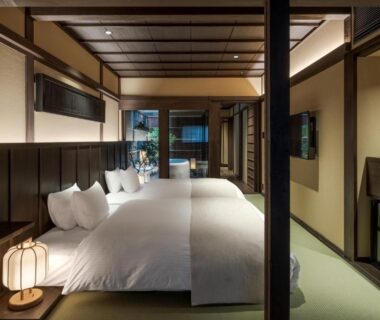 Tatami room with shoji screens and low beds at Nazuna Kyoto, Kansai