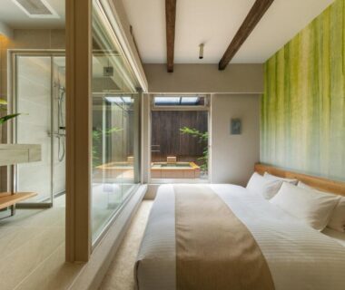 Contemporary ryokan bedroom with glass bathroom, wooden outdoor tub and small courtyard at Nazuna Kyoto Tsubaki St. Kyoto