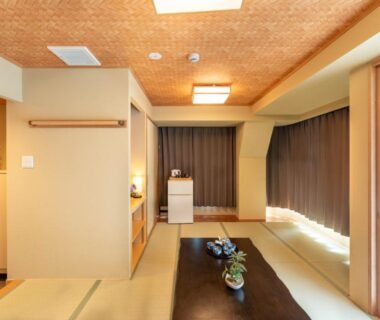 Traditional tatami room with low table, shoji screens and wooden ceiling at Nihonbashi Kakigara Ryokan in Tokyo