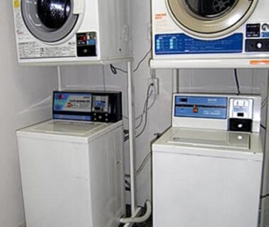 Stacked washers and dryers in Nihonkan guest laundry room, Kyoto