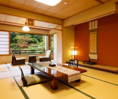 Traditional tatami room with low table, floor cushions, shoji screens and garden view at Nikko Hoshino Yado, Tochigi