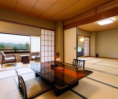 Spacious tatami room with low lacquered table, shoji screens and window seating at Nikko Hoshino Yado, Tochigi, Kantō