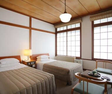 Twin beds with shoji screens and low table at Nikko Kanaya Hotel in Tochigi, Kantō
