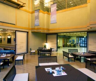 Spacious lobby dining area with low tables, bench seating and decorative high ceiling at Nikko Senhime Monogatari, Tochigi
