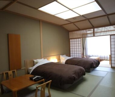 Tatami room with two beds, shoji screens and low table at Nikko Senhime Monogatari, Tochigi, Japan