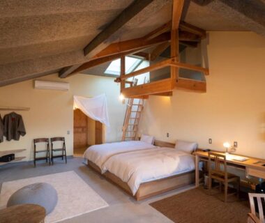 Loft-style room with twin beds, exposed beams, ladder and desk at Nisainoyuyado Asahiya, Oita
