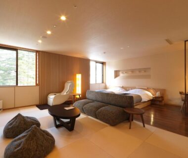 Tatami room with low seating and twin beds at Niseko Konbu Onsen Tsuruga Moku-no-sho, Hokkaidō Japan