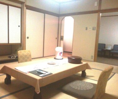 Traditional tatami room with low table, floor chairs and sliding shoji doors at Nissho Besso Kyoto