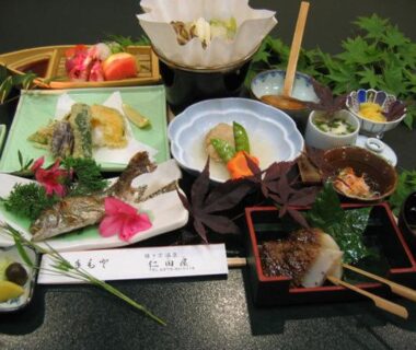 Assorted small dishes with grilled fish, vegetables and condiments on lacquer tray at Nitaya, Gunma ryokan