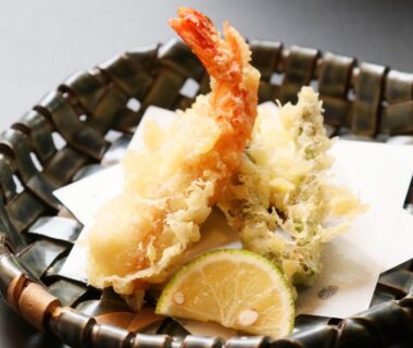 Crispy tempura prawns and vegetables in a woven basket at Nobori Ryokan Tokyo