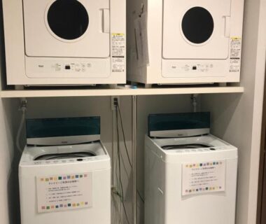 Two washers and two dryers in shared laundry at Nogami Honkan Ōita, Kyūshū, Japan