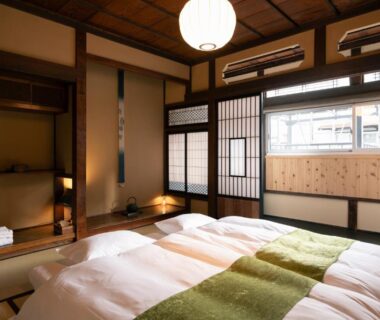 Traditional tatami room with twin futons, shoji screens, tokonoma alcove and wooden beams at Nunoya Ryokan in Nagano