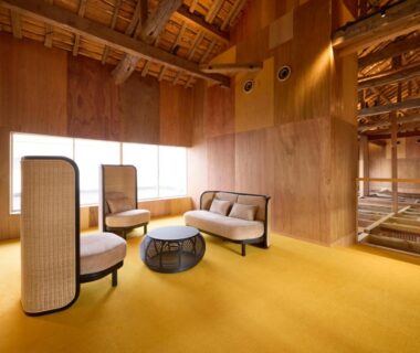 Wooden lounge with low seating, rattan screens and yellow carpet at ONCRI-Karatsu in Saga