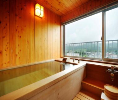 Indoor wooden soaking tub with window view, Oehonke ryokan, Hokkaidō