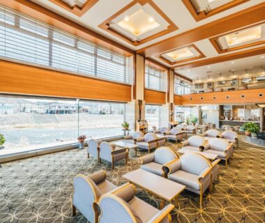 Spacious seating area with floor-to-ceiling windows at Oehonke, Hokkaidō, Japan