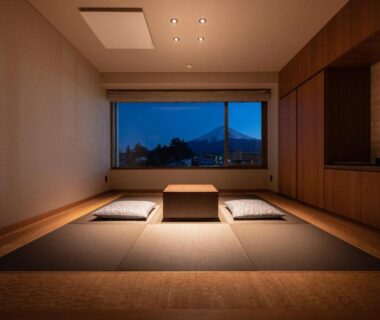 Tatami seating area with low table and cushions, window overlooking mountains at Oike Hotel Yamanashi