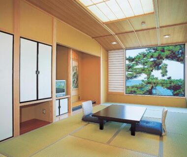Traditional tatami room with low table, shoji screens and tokonoma at Oishiya in Mie, Kansai