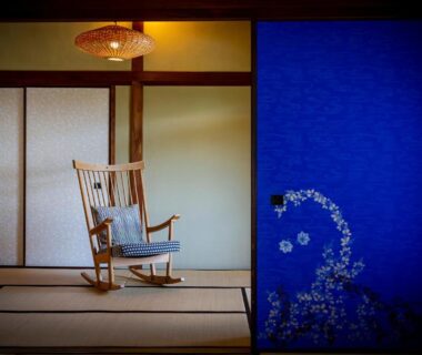 Wooden rocking chair on tatami with shoji screens and blue floral panel Okamotoya Ōita