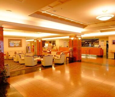 Spacious warmly lit lobby seating and reception at Okuhida Garden Hotel Yakedake in Gifu, Chūbu