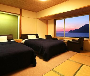 Tatami room with two Western beds and sea view at Okukinosaki Seaside Hotel Hyōgo