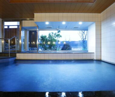 Tiled indoor bathing area with large window at Okukinosaki Seaside Hotel Hyōgo Kansai