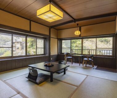 Tatami room with low table, zaisu chairs and large windows at Okyakuya, Kumamoto, Kyushu