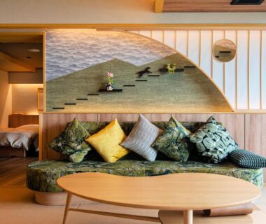 Tatami sitting area with low wooden table, patterned cushions and shoji screens at Omori, Gunma
