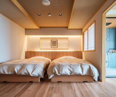 Twin bedroom with low beds, shoji screens and wooden floor at Omori in Gunma, Kantō