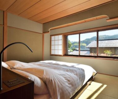 Sunlit tatami room with futon and shoji screens at Oni no Sumika, Shizuoka