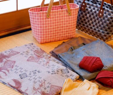 Folded yukata, obis and woven bags on tatami at Onishiya Suishoen, Hyōgo