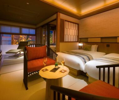 Warm tatami room with twin beds and shoji screens at Onomichi Hansei in Hiroshima, Chūgoku, Japan