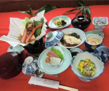 Assorted Japanese dishes on red cloth, Onsen Minshuku Sakaeya, Iwate, Tōhoku