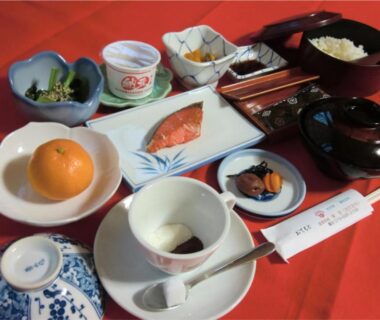 Traditional Japanese breakfast with grilled salmon, rice, miso soup, pickles and mandarin at Onsen Minshuku Sakaeya, Iwate