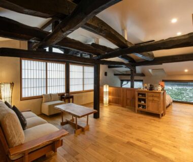 Spacious wooden interior with shoji screens and seating at Onsen and Garden Nana in Ishikawa, Chūbu, Japan