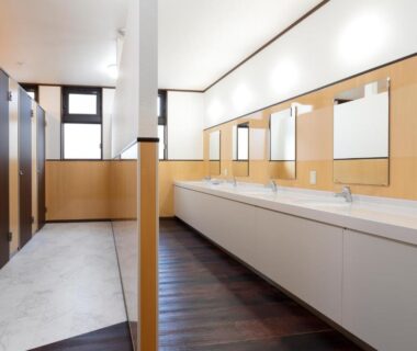 Communal vanity area with sinks and mirrors at Onsenminshuku Kosakaya, Wakayama